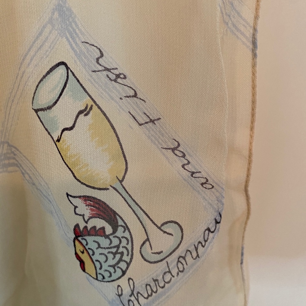 Chiffon scarf with prints of wine glasses and it says Chardonnay